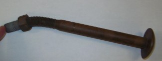 A brown metal rod with a nut