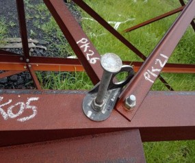 A metal bolt attached to a metal beam